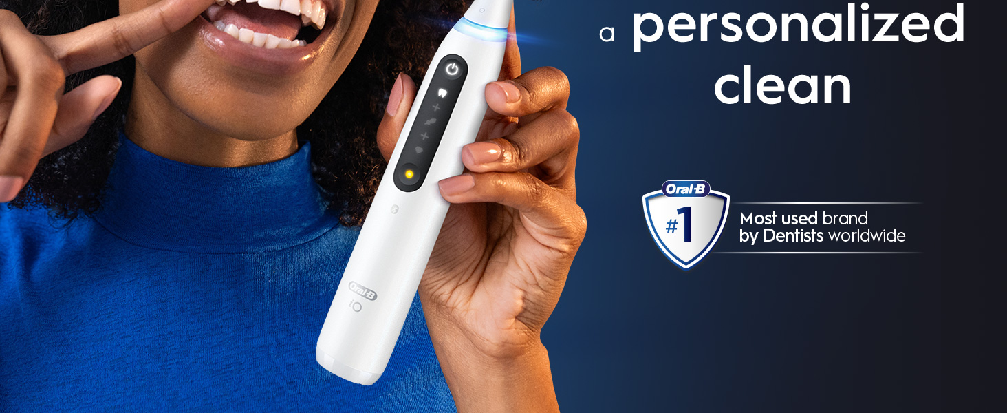 A person holds a white Oral-B iO toothbrush next to text that says a personalized clean and Oral-B #1 Most used brand by Dentists worldwide.