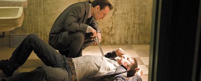 Jimmy Dolan Pointing A Gun At A Man Lying On The Floor