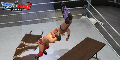 A wrestler being smashed through a table