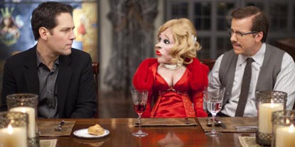 Tim Played By Paul Rudd Sat At A Table Next To A Man With A Female Ventriloquist Doll