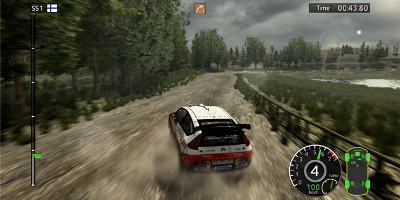 A Citroen C4 rally car getting sideways through a woodland environment