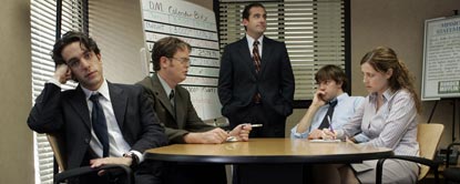 Michael Scott Stood At A White Board With Jim Halpert, Dwight Schrute, Ryan Howard And Pam Beesly Sat Round A Desk