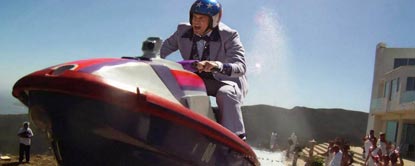 Johnny Knoxville In A suit And Helmet Sat On A Jet Ski
