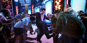 The player, kicking and punching their way through a mob of zombies
