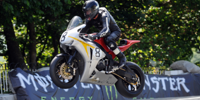 A Silver Motorbike Going Over A Jump