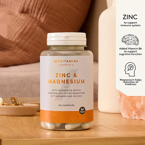 Image 1 - A clear bottle of Myvitamins Zinc & Magnesium capsules with a white label reading Myvitamins Essentials Zinc & Magnesium with Magnesium which contributes to the reduction of tiredness and fatigue 30 Capsules Vegan Friendly is displayed on a wooden surface next to a white panel detailing benefits: Zinc to support immune system, Added Vitamin B6 to support cognitive function, and Magnesium helps reduction of tiredness. Image 2 - A light peach-colored review card displays five white stars and the text: Started to take these every night and within a week/2 weeks I was feeling more relaxed and less anxious at night! I was surprised as weeks went on that I felt better and better from it! Waking up feeling more energised and ready for the day! Verified Myvitamins Customer.