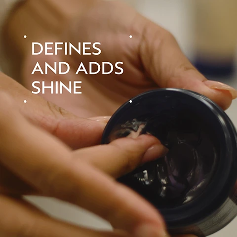 Image 2 - A persons hands are shown dipping a finger into a dark jar of hair product, with the text Defines and Adds Shine overlaid. Image 3 - A dark green image with a white circle revealing pink rose petals, a white jasmine flower, and cloves, with the text BLISSFUL PURE-FUME AROMA AN AROMATIC BLEND WITH JASMINE, ROSE, CERTIFIED ORGANIC CLOVE AND OTHER PURE FLOWER AND PLANT ESSENCES. Image 4 - A split image shows a persons curly hair before treatment with frizzy, less defined curls, and after treatment with shiny, well-defined curls. Visible text: BEFORE, AFTER, Unwashed Hair, Results with Brilliant Shampoo, Conditioner, Damage Control, Retexturing Gel, Humectant Pomade, Hair Spray, and Wooden Paddle Brush. Blow dried with diffuser attachment. Image 5 - A four-step hair care guide on a dark green background, showing hands applying products in circular images, with the visible text HOW TO USE, 01 CLEANSE Brilliant™ Shampoo, 02 CONDITION Brilliant™ Conditioner, 03 PREP Brilliant™ Damage Control, and 04 STYLE Brilliant™ Retexturing Gel, Humectant Pomade and Hair Spray. Image 6 - A clear, viscous gel with small air bubbles is swiped on a white background. Image 7 - A womans dark curly hair is shown in a side-by-side comparison, with the left image showing it frizzy and less defined, and the right image showing it shiny, well-defined, and moisturized, accompanied by the text BEFORE, Unwashed Hair, AFTER, Results with Brilliant Shampoo, Conditioner, Damage Control, Retexturing Gel, Humectant Pomade, Hair Spray, and Wooden Paddle Brush. Blow dried with diffuser attachment. Image 8 - The image shows various green leaves and a red plant stem in the foreground, with three white certification logos overlaid: a 100% VEGAN logo with a large V in the center, a Certified B Corporation logo, and a Cruelty Free International leaping bunny logo.