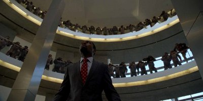 Man Looking Up Surrounded By Chimpanzees