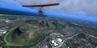 A small, microlight aircraft, flying over the hill in the above picture