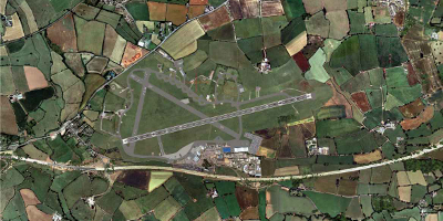 A bird's eye view of an airfield, with it's main runway clearly visible
