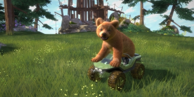 A small brown bear on top of a small vehicle