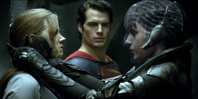 Woman clutching Woman with Man of Steel in Background
