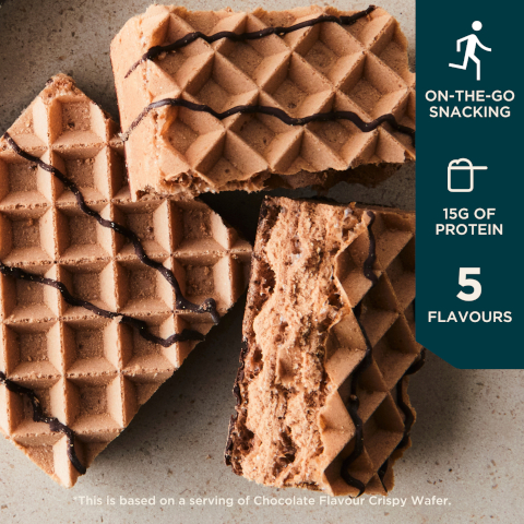 Image 1 - Three chocolate-flavored crispy wafers are displayed on a light plate with drizzled chocolate on top, accompanied by text stating ON-THE-GO SNACKING, 15G OF PROTEIN, and 5 FLAVOURS, with a note that this is based on a serving of Chocolate Flavour Crispy Wafer.