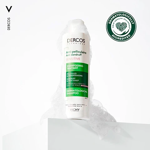 Image 1 - A bottle of Dercos Anti-Dandruff Shampoo, covered in bubbles, is placed on a white surface with a green and white dermatological accreditation seal in the top right corner.
              Image 2 - A close-up image of a person with dark, curly hair holding their hair back, accompanied by text that reads REMOVES VISIBLE FLAKES FROM FIRST USE FOR SENSITIVE SCALP.
              Image 3 - A young man with curly hair poses with one hand on his head, showcasing tattoos on his arms, with the text UP TO 6 WEEKS ANTI-DANDRUFF PROTECTION* displayed in green at the bottom.
              Image 4 - Image shows two sections with textured backgrounds: the left side has the text 1.3% SALICYLIC ACID, and the right side features 1% PIROCTONE OLAMINE, with the caption DERCOS LEAVES SENSITIVE SCALP FEELING SOOTHED & BALANCED at the bottom.
              Image 5 - Image shows bubbles against a light background with the text Gentle Formulation + Pleasant Texture + Leaves Hair Feeling Clean & Comforted.