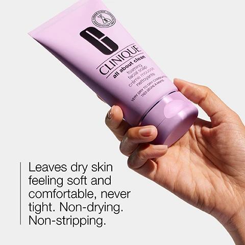 Image 1 - A person is holding a tube of Clinique All About Clean Foaming Facial Soap, which is purple with a prominent black letter G and the Clinique logo, alongside text that reads Leaves dry skin feeling soft and comfortable, never tight. Non-drying. Non-stripping.
              Image 2 - The image shows two transparent dishes, one containing a clear gel labeled Hyaluronic acid and the other a thicker, creamy substance labeled Glycerin.