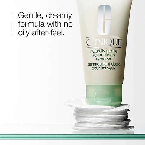 Image 1 - A tube of Clinique naturally gentle eye makeup remover sits on a stack of cotton pads, with the text reading Gentle, creamy formula with no oily after-feel.
              Image 2 - A smear of white cream is shown against a plain background, with the text dissolve eye makeup prominently displayed next to it.
              Image 3 - A close-up of a clear glass object beside a light green striped background, showing a list with check marks indicating it is free of fragrance, gluten, sodium lauryl sulfate, and sodium laureth sulfate.