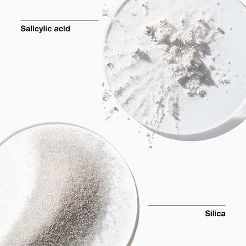 Image 1 - Image shows a close-up view of two petri dishes containing Salicylic acid, which appears as a white powdery substance on the top, and Silica, which consists of small, translucent granules at the bottom, with the labels Salicylic acid and Silica positioned beside each dish.
              Image 2 - A green background lists various ingredients marked with a cross, indicating they are not included, such as fragrance, gluten, oil, drying alcohol, sodium lauryl sulfate, and sodium laureth sulfate.