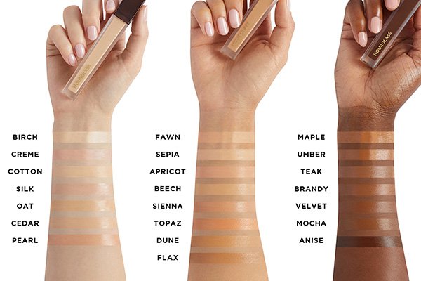 swatches of birch, creme, cotton, silk, oat, cedar, pearl, fawn, sepia, apricot, beech, sienna, topaz, dune, flax, maple, umber, teak, brandy, velvet, mocha and anise on three different skin tones.