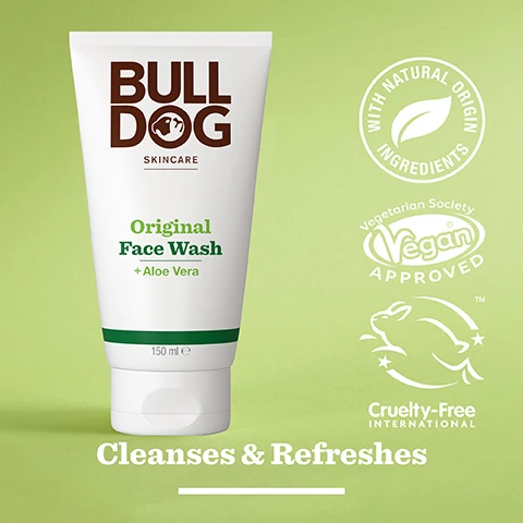 Image 2 - A tube of Bulldog Original Face Wash with aloe vera, featuring a green label and various certification logos indicating vegan and cruelty-free status, against a light green background, with the text Cleanses & Refreshes.
              Image 3 - A close-up of a green aloe vera leaf with a glistening gel surface, featuring the text 94% Natural Origin, Unlock the true potential of natural origin ingredients, and Aloe Vera.
              Image 4 - A hand pours a clear facial wash labeled Original Face Wash + Aloe Vera into another hand, with text below reading Normal To Dry Skin.
              Image 5 - A person is holding a white tube of Bulldog Skincare Original Face Wash, which features green text on the front and rests on a marble countertop next to a green towel, with visible text indicating that the tube is made from recycled materials.