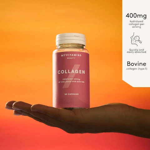 A hand holds a pink bottle of Myvitamins Beauty Collagen capsules against an orange background with text descriptions to the right. The visible text is MYVITAMINS BEAUTY COLLAGEN CONTAINS 400mg OF COLLAGEN PER SERVING 90 CAPSULES 400mg hydrolysed collagen per serving Quickly and easily absorbed Bovine collagen type 1.
