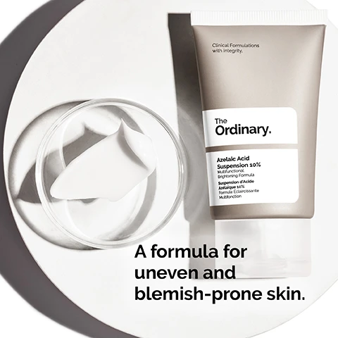 Image 1 - A tube of The Ordinary Azelaic Acid Suspension 10% is placed beside a small dish containing a cream, with text at the bottom reading A formula for uneven and blemish-prone skin.
              Image 2 - A woman gently applies a cream-like substance to her cheek, with visible text that reads Cream-like texture and 10% Azelaic Acid brightens skin tone and noticeably improves skin texture.
              Image 3 - A smooth, white surface with curved lines and visible text that reads Apply daily in the morning and evening. Use sun protection during the day.
              Image 4 - Image showing three categories of skincare products labeled as PREP, TREAT, and SEAL with corresponding product types: cleansers and toners under PREP, water-based serums, eye serums, anhydrous solutions, and oils under TREAT, and suspensions, moisturizers, and SPF under SEAL.