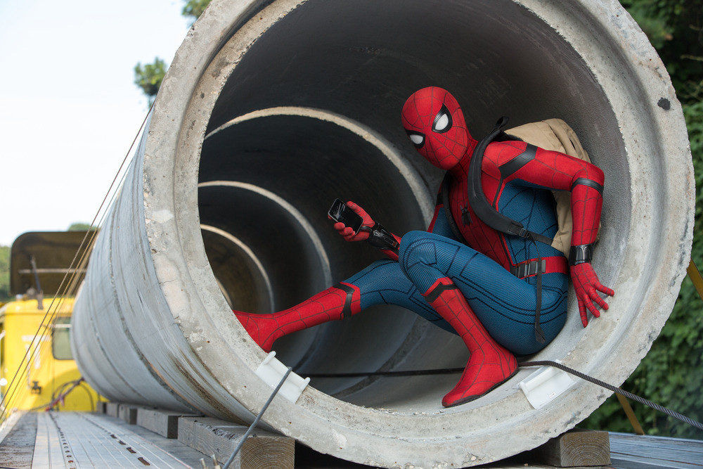 Image showing Spiderman sitting inside a concrete pipe