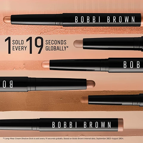 Image 1 - Image shows multiple Bobbi Brown Long-Wear Cream Shadow Sticks arranged on a soft, light-colored background with the text 1 SOLD EVERY 19 SECONDS GLOBALLY* prominently displayed.
              Image 2 - An image of a Bobbi Brown cosmetic stick placed against a background of various neutral shades, featuring text that highlights its features: 24HR Longwear, 24HR Crease and Smudge Proof Wear, Creamy, Rich, Blendable Colour, and Water and Sweat Proof.
              Image 3 - Image shows three makeup products arranged in a row, with A FLAWLESS ROUTINE at the top and labeled steps beneath each product; from left to right: a brown Long-Wear Cream Shadow Stick, a black Long-Wear Cream Liner Stick, and a white Smokey Eye Mascara.