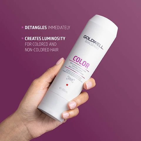 Image 1 - A hand holds a white Goldwell Dualsenses Color Brilliance Conditioner bottle against a purple background, with visible text on the bottle reading Goldwell Dualsenses, Color, Brilliance Conditioner, Soin Brillance, Brillanz Conditioner, and e 200 ml, along with promotional text to the left stating Detangles Immediately and Creates Luminosity for Colored and Non-Colored Hair. Image 2 - A white Goldwell Dualsenses Color Brilliance Conditioner 200mL bottle is shown with a swirl of pinkish-purple conditioner below it, and accompanying text states THE NEXT GENERATION OF COLOR LUMINOSITY, The new Luminescine technology transforms non-visible UV light into visible light for magnificent brilliance, MicroPROtec complex + FadeStopFormula + Luminescine = SUPERB COLOR BRILLIANCE. Image 3 - A white Goldwell Dualsenses Color Brilliance Conditioner bottle is centered on a magenta background, displaying the text GOLDWELL DUALSENSES COLOR BRILLIANCE CONDITIONER SOIN BRILLANCE BRILLANZ CONDITIONER e 200 mL, and at the bottom, ClimatePartner certified product climate-id.com/PBNVQ3 CO2 measure reduce contribute.