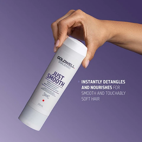 Image 1 - A hand holds a white Goldwell Dualsenses Just Smooth Taming Conditioner bottle on a purple background, with visible text Goldwell Dualsenses Just Smooth Taming Conditioner Soin Disciplinant Bändigungs Conditioner for coloured & non-coloured hair 200 mL, and additional text Instantly detangles and nourishes for smooth and touchably soft hair. Image 2 - A white Goldwell Dualsenses Just Smooth conditioner bottle is shown with a dollop of white cream above it and two clear liquid drops below, alongside text that reads GOLDWELL DUALSENSES JUST SMOOTH TAMING CONDITIONER SOIN DISCIPLINANT BÄNDIGUNGS CONDITIONER CONTROL FOR UNRULY HAIR CONTROLE POUR CHEVEUX REBELLES KONTROLLE FÜR WIDERSPENSTIGES HAAR COLOR PROTECTION 200mL, and additional text describing KUKUI NUT OIL, which is known for its moisturizing effect, and whose active ingredient combination helps to even the hair surface and smoothes the hair structure for improved manageability, easy detangling and frizz control. Image 3 - A white bottle of Goldwell DUALSENSES JUST SMOOTH Taming Conditioner is shown on a purple background with text that reads: GOLDWELL DUALSENSES JUST SMOOTH TAMING CONDITIONER SOIN DISCIPLINANT BÄNDIGUNGS CONDITIONER CONTROL FOR UNRULY HAIR CONTROLE POUR CHEVEUX INDISCIPLINÉS KONTROLLE FÜR WIDERSPENSTIGES HAAR COLOR PROTECTION 200mL ClimatePartner certified product climate-id.com/PBNVQ3 CO2 measure reduce contribute.