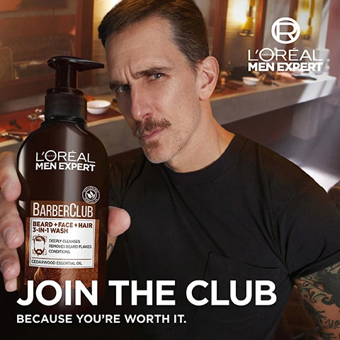 Image 2 - A man with a mustache and a black t-shirt holds a LOréal Men Expert BarberClub Beard + Face + Hair 3-IN-1 Wash bottle, with the text LOréal Paris Men Expert, BarberClub, Beard + Face + Hair 3-IN-1 Wash, Cedarwood Essential Oil, JOIN THE CLUB, and BECAUSE YOURE WORTH IT visible. Image 3 - A smiling man with dark hair and a beard, wearing a brown jacket and rings, touches his chin, with the text 3-IN-1 BEARD, FACE & HAIR, LIGHT FORMULA, and NON-GREASY TEXTURE. Image 4 - A textured background of dark brown wood with a wavy stream of white cream or liquid flowing diagonally across it, featuring text that reads: FORMULA WITH [CEDARWOOD ESSENTIAL OIL] FROM NATURAL ORIGIN, and a circular logo in the bottom left stating VEGAN FRIENDLY. NO ANIMAL DERIVED INGREDIENTS. LORÉAL PARIS., alongside the text NO COLORANT NO PARABENS NO SOAP.