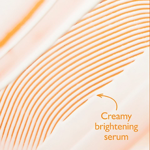 Image 1 - Creamy white product swirled with wavy orange lines, with an orange arrow pointing to the text Crema brightening serum. Image 2 - A split image shows the right side of a womans face before and after one week, with the after side displaying brighter, more even-toned skin with fewer visible lines, and includes text that reads BEFORE, AFTER 1 WEEK, Skin appears brighter and more even-toned, and Unretouched photos. Individual results may vary. Image 3 - A split-panel before and after comparison image of a persons lower face, showing skin with blemishes and discoloration in the top panel and visibly clearer skin with reduced imperfections in the bottom panel, with the text BEFORE, AFTER 4 WEEKS*, Dark spots and discoloration look reduced., and *Unretouched photos. Individual results may vary. Image 4 - The image displays a list of seven signs of aging on a soft orange and white background with the text Defy 7 Signs of Aging* 1. Fine Lines 2. Wrinkles 3. Uneven Tone 4. Loss of Brightness 5. Loss of Firmness 6. Uneven Texture 7. Dehydration *Based on a 4-week consumer perception study on 33 women ranging in age from 49 to 65.