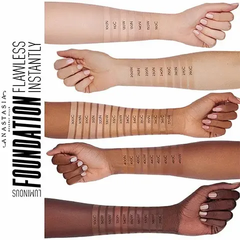 Luminour foundation, flawless instantly. There are five arms on this image in total with various skin tones. Each arm contains labelled colour swatches for each shade,    they are anmed via a number and not a name. This number correlates to an exact colour as they are available in 5 shade categories (Fair, Light, Medium, Tan, Deep) and 3 undertones (Cool, Warm, Neutral) The numbers are: 500C, 510W, 520W, 530W, 540W, 550W, 560W, 570N, 580W, 590C, 400 N, 410C 420C, 430W, 440C, 470C, 480C, 490W, 300C, 305N, 310C, 315N, 320N, 330W, 332C, 333W, 340C, 345C, 350C, 355N, 360C, 365C, 370W, 200W, 210N, 220N, 230N, 240N, 250C, 260N, 270C, 290C, 100N, 110C, 120W, 130N, 150W and 160C.
