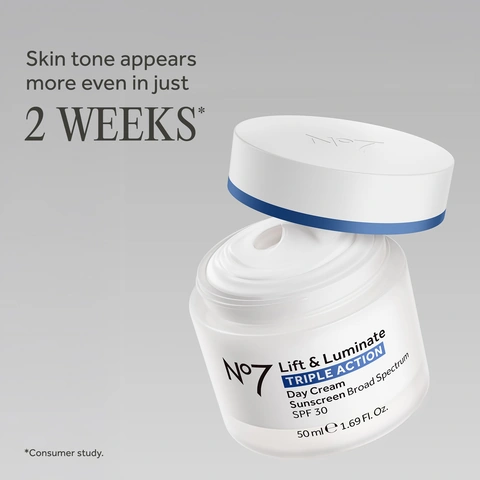 Image 2-noseven-en_US - Open white jar of cream labeled No7 Lift & Luminate Triple Action Day Cream Sunscreen Broad Spectrum SPF 30. Image 3-noseven-en_US - Open light blue jar of white face cream labeled No7 Lift & Luminate Triple Action Night Cream.