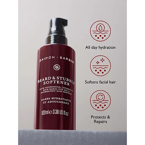 Image 3 - A dark red Daimon Barber Beard & Stubble Softener bottle with a black pump dispenser is displayed, with bottle text reading DAIMON BARBER DB BEARD & STUBBLE SOFTENER WITH NOURISHING, VITAMIN-E RICH KAHAI NUT OIL & HYDROLYSED SILK PROTEIN BARBE HYDRATANTE ET ADOUCISSANT 100mle 3.38 US fl.oz, alongside three icons and their descriptions: All day hydration, Softens facial hair, and Protects & Repairs. Image 5 - A close-up, grayscale image of a mans mouth, chin, and beard with a red circular badge in the bottom right corner that reads HYDRATES FOR UP TO 48 HOURS.