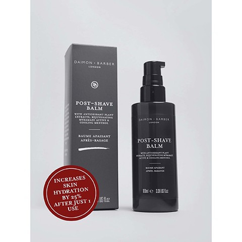 Image 3 - A black Daimon Barber London Post-Shave Balm pump bottle and its matching box are shown with text that reads DAIMON BARBER LONDON POST-SHAVE BALM WITH ANTIOXIDANT PLANT EXTRACTS, REJUVENATING MYRAMAZE ACTIVE & COOLING MENTHOL BAUME APAISANT APRES-RASAGE 100ml e 3.38 US FL.OZ, alongside a red circular badge stating INCREASES SKIN HYDRATION BY 25% AFTER JUST 1 USE.