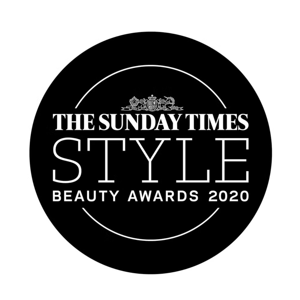 A black circular logo features a white royal crest at the top, followed by the text The Sunday Times Style Beauty Awards 2020, with two curved white lines above and below the text.