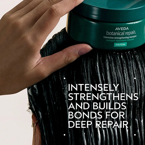 Image 2 - A hand applies a dark green jar of Aveda Botanical Repair intensive strengthening masque to wet, dark hair, with visible text on the jar reading AVEDA botanical repair intensive strengthening masque masque réparateur intense rich/riche, and overlaid text saying INTENSELY STRENGTHENS AND BUILDS BONDS FOR DEEP REPAIR. Image 3 - A split image shows a before and after comparison of dark hair: on the left, frizzy, unwashed hair with the text BEFORE and Unwashed Hair, and on the right, smooth, straightened hair with the text AFTER and Results with botanical repair™ strengthening shampoo, intensive strengthening masque: rich and strengthening leave-in treatment. Blow dried with round bristle hair brush. Image 4 - The image shows a dark green background with a large circular design element featuring swirling green and yellowish-brown liquid, accompanied by white text reading: PLANT-DERIVED BOND BUILDING MOLECULE PLANT-DERIVED BOND BUILDING MOLECULE PENETRATES DEEP WITHIN THE CORTEX BUILDING NEW BONDS FOR STRONGER HAIR. NOURISHING MACRO-GREEN BLEND WITH AVOCADO, GREEN TEA AND SACHA INCHI OILS SMOOTHS THE CUTICLE TO DETANGLE AND HELP PREVENT BREAKAGE. Image 5 - A four-step hair care routine image on a green background, illustrating HOW TO USE: 01 CLEANSE with hands lathering shampoo into dark hair, botanical repair™ strengthening shampoo; 02 CONDITION with dark hair covered in a white conditioning product, botanical repair™ strengthening masque: rich; 03 REPAIR with a hand squeezing a teal tube dispensing white product, botanical repair™ strengthening leave-in treatment and botanical repair™ bond-building flash treatment; and 04 STYLE with a hand combing through damp reddish-brown hair, botanical repair™ strengthening bond building styling crème. Image 6 - A smooth, thick white swash of cream or lotion is displayed diagonally on a white background. Image 7 - Three white logos are displayed on a dark green tropical leaf background with a red plant on the left, showing the text 100% VEGAN, Certified B Corporation, and Cruelty Free INTERNATIONAL.