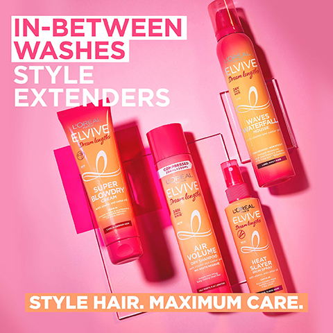 Four LOréal Elvive Dream Lengths hair styling products, consisting of an orange tube, two orange aerosol cans, and a small orange spray bottle, are displayed on a vibrant pink background with visible text reading IN-BETWEEN WASHES STYLE EXTENDERS, LORÉAL PARIS ELVIVE Dream lengths NEW SUPER BLOWDRY CREAM with vitamin and castor oil LEAVE-IN nourish lengths & ease blowdry repositionable definition 72h shape memory LONG, BLOWDRIED HAIR, COMPRESSED 200ML=300ML LORÉAL PARIS ELVIVE Dream lengths 24H SCENTED HAIR NEW AIR VOLUME DRY SHAMPOO with vitamin and castor oil NO WHITE RESIDUE instant root lifting long-lasting clean feel OILY ROOTS, FLAT LENGTHS, LORÉAL PARIS ELVIVE Dream lengths 24H SCENTED HAIR NEW WAVES WATERFALL MOUSSE with vitamin and castor oil NON CRUNCHY - NON STICKY instant moisture soft and bouncy waves 48h hold and definition LONG, WAVY HAIR, LORÉAL PARIS ELVIVE Dream lengths NEW HEAT SLAYER IRON SPRAY with vitamin and castor oil LEAVE-IN heat damage shield humidity-proof 3 day sleek LONG, SLEEK HAIR, and STYLE HAIR. MAXIMUM CARE.