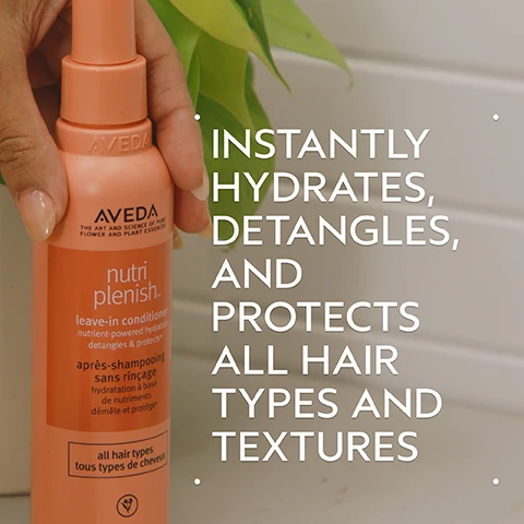 Image 2 - A hand holds an orange Aveda nutriplenish leave-in conditioner bottle against a background of green leaves and a light wall, featuring text on the bottle: AVEDA THE ART AND SCIENCE OF PURE FLOWER AND PLANT ESSENCES nutri replenish leave-in conditioner nutrient-powered hydration detangles & protects* après-shampooing sans rinçage hydratation à base de nutriments démêle et protège* all hair types tous types de cheveux, and prominent white text overlaid on the right side of the image reads INSTANTLY HYDRATES, DETANGLES, AND PROTECTS ALL HAIR TYPES AND TEXTURES. Image 3 - A dark green background features a circular image of glistening dark red pomegranate arils against a light blue and orange background, with white text reading POMEGRANATE OIL and HELPS PROVIDE NUTRIENT-POWERED HYDRATION. Image 4 - A before and after comparison image shows a woman with dark curly hair; on the left, her hair is voluminous and somewhat frizzy, while on the right, her hair is shinier with more defined curls and a neater appearance, with text that reads BEFORE, AFTER, Unwashed Hair, Results with Nutriplenish ™ Shampoo and Conditioner: Deep Moisture, Nutriplenish Leave-In Conditioner, Curl Gelee, Replenishing Overnight Serum and Wooden Paddle Brush. Blow dried with diffuser attachment. Image 5 - Three white, round drops of liquid, with one large drop at the bottom left and two smaller drops above and to the right, are shown against a white background. Image 6 - Image showing three steps for hair care: a person shampooing their hair, hands dispensing white conditioner from a red tube, and hands dispensing clear gel from a pink tube, with the text How To Use 01 Cleanse Nutriplenish Shampoo: Deep Moisture 02 Condition Nutriplenish Conditioner: Deep Moisture & Leave-In Conditioner 03 Style Nutriplenish Curl Gelee & Replenishing Overnight Serum. Image 7 - Three white certification logos are displayed against a background of dark green tropical leaves: a circular logo with a large V and the text 100% Vegan, a Certified B Corporation logo, and a Leaping Bunny logo with the text Cruelty Free INTERNATIONAL.
