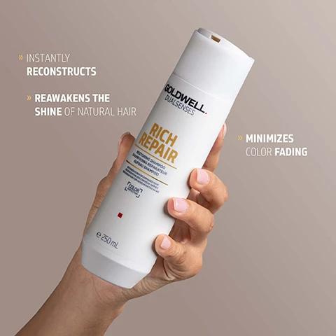 Image 1 - A hand holds a white Goldwell DUALSENSES Rich Repair shampoo bottle labeled RESTORING SHAMPOO, SHAMPOOING REPARATEUR, AUFBAU SHAMPOO, COLOR PROTECTION FOR DAMAGED HAIR, CHEVEUX ABÎMÉS, GESCHÄDIGTES HAAR, e 250 mL, with the benefits INSTANTLY RECONSTRUCTS, REAWAKENS THE SHINE OF NATURAL HAIR, and MINIMIZES COLOR FADING displayed around it. Image 2 - A persons hands hold a white tub of Goldwell Dualsenses Rich Repair Masque, with accompanying text that reads: RESTORES DAMAGED HAIR STRUCTURES FROM DEEP INSIDE, NOURISHES & REVITALIZES IN JUST 60 SECONDS, LEAVES HAIR SMOOTHER, SHINIER, & PROVIDES MORE MANAGEABILITY. Image 3 - A white bottle of Goldwell Dualsenses Rich Repair Restoring Shampoo, 250 mL, is displayed with a blob of clear shampoo beside it, alongside descriptive text that reads INTRALIPID COMPLEX – REPAIR FROM INSIDE THE HAIR, Lipids are replaced effectively and deeply – for intensive regeneration of the inner hair structure, and REPAIR OF THE HAIR SURFACE, The damaged lipid structure of the cuticula layer is repaired. Image 4 - A white jar of Goldwell Dualsenses Rich Repair 60sec Treatment Masque, with a swirl of white cream and a clear liquid drop, displays text GOLDWELL DUALSENSES RICH REPAIR 60SEC TREATMENT MASQUE REGENERATION FOR DAMAGED HAIR COLOR PROTECTION 200ml / 6.7 FL.OZ. and additional text INTRALIPID COMPLEX - REPAIR FROM INSIDE THE HAIR Lipids are replaced effectively and deeply - for intensive regeneration of the inner hair structure REPAIR OF THE HAIR SURFACE The damaged lipid structure of the cuticula layer is repaired. Image 5 - A white upright shampoo bottle is shown with the text GOLDWELL DUALSENSES RICH REPAIR RESTORING SHAMPOO SHAMPOOING RÉPARATEUR AUFBAU SHAMPOO REGENERATION FOR DAMAGED, STRESSED HAIR. REGENERATION POUR CHEVEUX ABIMÉS ET STRESSÉS. REGENERATION FÜR GESCHÄDIGTES, STRAPAZIERTES HAAR. COLOR LUXURY e 250 mL, and below the bottle, ClimatePartner certified product climate-id.com/PBNVQ3 CO2 measure reduce contribute. Image 6 - A white jar of Goldwell Dualsenses Rich Repair 60sec Treatment for damaged hair, 200ml, is shown with a ClimatePartner certified product label, a QR code, and text reading CO2 measure reduce contribute.