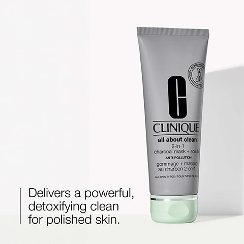 Image 1 - A silver tube of Clinique All About Clean 2-in-1 Charcoal Mask + Scrub is displayed, with visible text reading Delivers a powerful, detoxifying clean for polished skin and ANTI-POLLUTION.
              Image 2 - A smear of gray exfoliating product is shown on a white background, with the words exfoliate and refine accompanied by icons for each term.