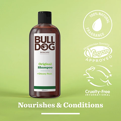 Image 2 - A brown bottle of Bulldog Original Shampoo with green accents is displayed on a light green background, featuring text that reads Bulldog skincare, Original Shampoo, +Chicory Root, 300ml, and the phrases Nourishes & Conditions, 100% Natural Fragrance, Vegan Approved, and Cruelty-Free International.
              Image 3 - Dried pieces of chicory root scattered on a light marble surface with the text 100% Natural Fragrances and Chicory Root.
              Image 4 - A person with a light brown skin tone is holding a bottle of Bull Dog Original Shampoo, tilting it to pour a small amount into their open palm, with the text Nourishes & Conditions visible below in a large font.
              Image 5 - A hand holds a brown shampoo bottle labeled Bulldog Skincare Original Shampoo + Chicory Root, and there is a circular graphic indicating the bottle is made from 100% recycled PCR plastic.
              Image 6 - Two bottles of Bulldog Skincare products are displayed on a tiled surface, with the left bottle labeled Original Shower Gel and the right bottle labeled Original Shampoo, both featuring green accents and additional text about their benefits; the text at the bottom reads Start the Day Right.