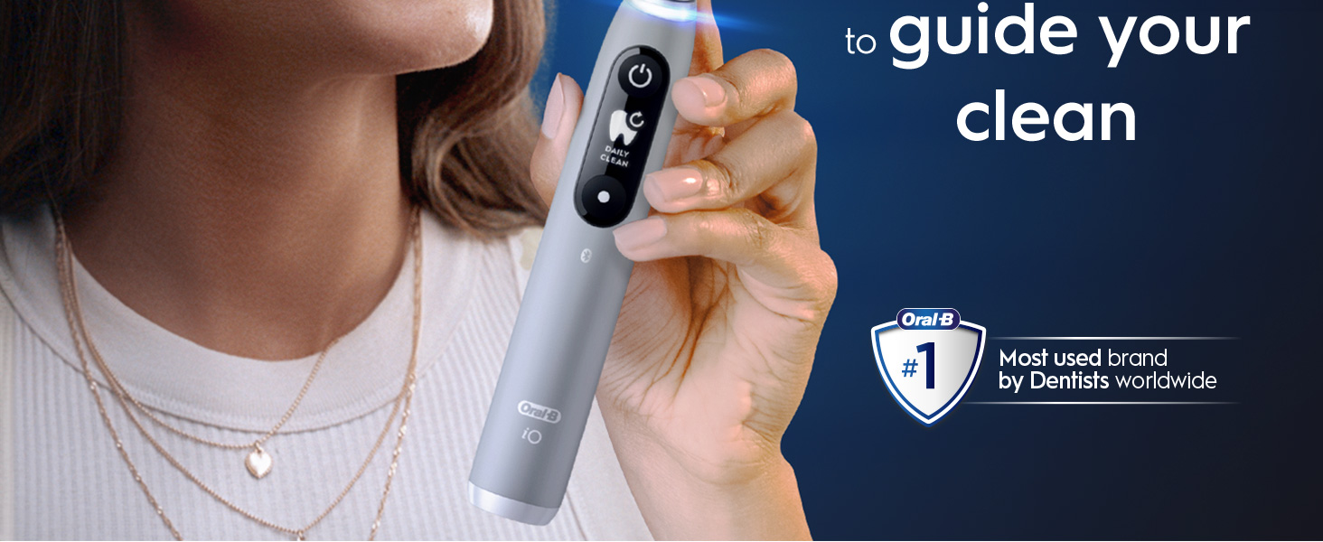 A hand holding an Oral-B toothbrush with a claim 'To guide your clean, #1 dentist-recommended brand'