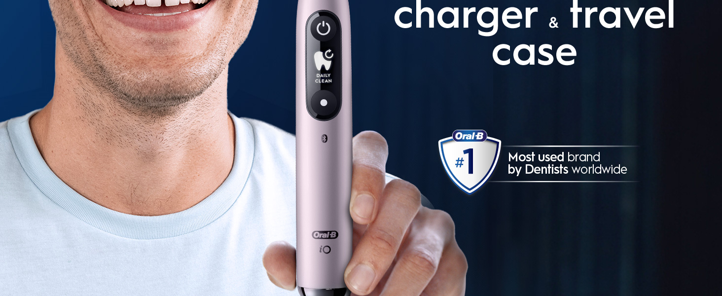 A hand holding a pink Oral-B iO9 toothbrush with a no.1 dentist claim