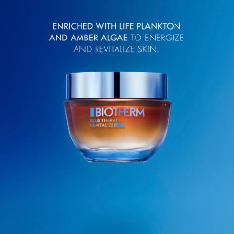 Image GIF1 - A jar of Biotherm Blue Therapy Revitalize cream with a silver lid sits on a blue background. Text reads: ENRICHED WITH LIFE PLANKTON AND AMBER ALGAE TO ENERGIZE AND REVITALIZE SKIN. BIOTHERM BLUE THERAPY REVITALIZE.