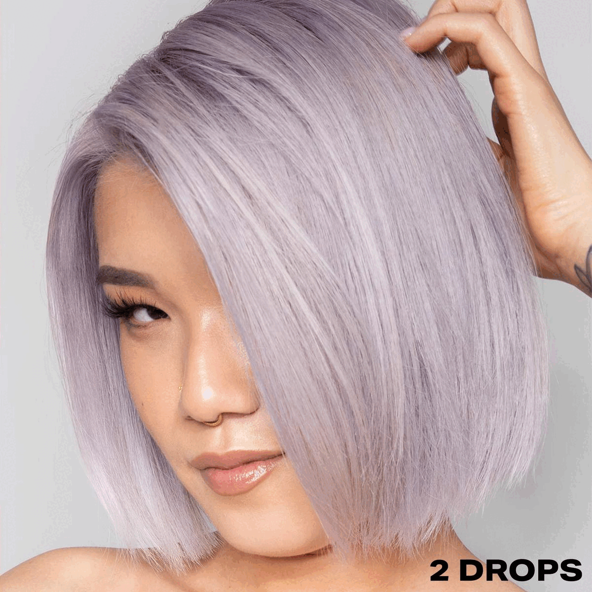 GIF transitioning between two images. Image 1- modelling hair that has used the 'SHRINE Drop It Lilac Toner'. Text: 2 drops. Image 2- showing before and after use of the toner. Text: 2 drops