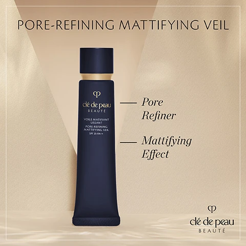 Image 1 - A dark blue cosmetic tube with a gold cap, labeled clé de peau BEAUFÉ and PORE-REFINING MATTIFYING VEIL, displayed against a soft, light-colored background, with additional text stating Pore Refiner and Mattifying Effect, as well as SPF 25+PA++.
              Image 2 - A woman with long brown hair, wearing a navy blue blazer, touches her cheek with one hand while showcasing a natural makeup look, with text overlay that reads Visibly reduces pores appearance & shininess to improve skin texture along with the brand logo for clé de peau BEAUTE.
              Image 3 - A woman with brown hair tied back is holding a dark bottle while looking directly at the camera, wearing a navy blazer and gold hoop earrings, with text that reads In 2 weeks, pores appearance looks tightened & skin texture smoother* *98% of 102 women agreed after self-assessment.