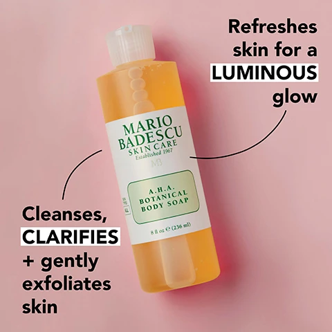 Image 1 - A bottle of Mario Badescu A.H.A. Botanical Body Soap is shown, with text highlighting its benefits: Refreshes skin for a LUMINOUS glow and Cleanses, CLARIFIES + gently exfoliates skin.
              Image 2 - An arrangement of grapefruit halves, dried ginseng slices, and small droplets of oil, with the text rejuvenating grapefruit extract, invigorating + antioxidant-rich ginseng extract, and exfoliating glycolic acid.