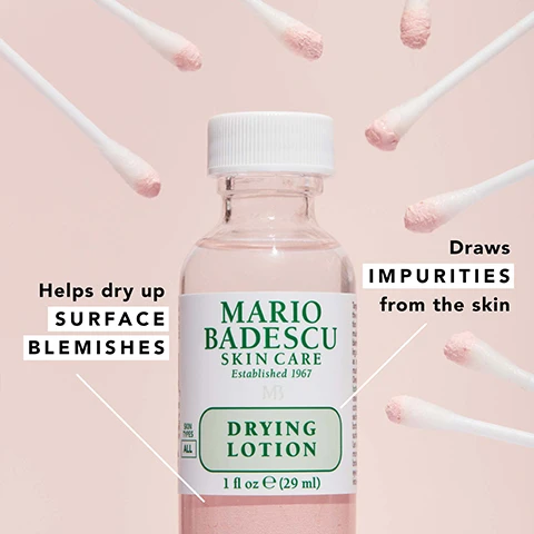 Image 1 - A bottle of Mario Badescu Drying Lotion is centered in the image, surrounded by cotton swabs; the bottle features the text Mario Badescu Skin Care, Established 1967, and Drying Lotion, with additional text stating Helps dry up surface blemishes and Draws impurities from the skin.
              Image 2 - Image shows a colorful background with powder-like textures in pink, yellow, and tiny bubbles, featuring the following text: exfoliating + pore-cleansing salicylic acid, oil-inhibiting sulfur, soothing calamine (cooling camphor).
              Image 3 - An image of a Mario Badescu skin care product featuring a box labeled DRYING PATCH with the text stating it contains 60 adhesive patches for daytime use, alongside a bottle of DRYING LOTION with instructions indicating to apply it before bed for overnight results, with icons representing morning and night.
              Image 4 - An arrangement of skincare products on a pink background, including a bottle of Mario Badescu Original Drying Lotion, a jar of Pore Minimizer, a jar of Drying Mask, and a box of Drying Patch, with text highlighting their uses for blemishes, blackheads, and excess oil.
