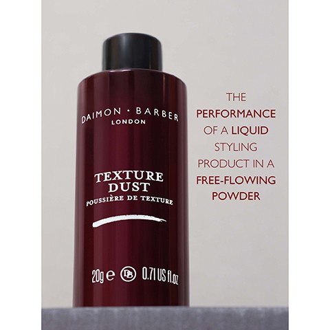Image 3 - A dark red bottle of Daimon Barber London Texture Dust stands on a gray surface, with text on the bottle reading Daimon Barber London Texture Dust Poussiere de Texture 20g e and 0.71 US fl.oz, and additional text next to the bottle stating The performance of a liquid styling product in a free-flowing powder.